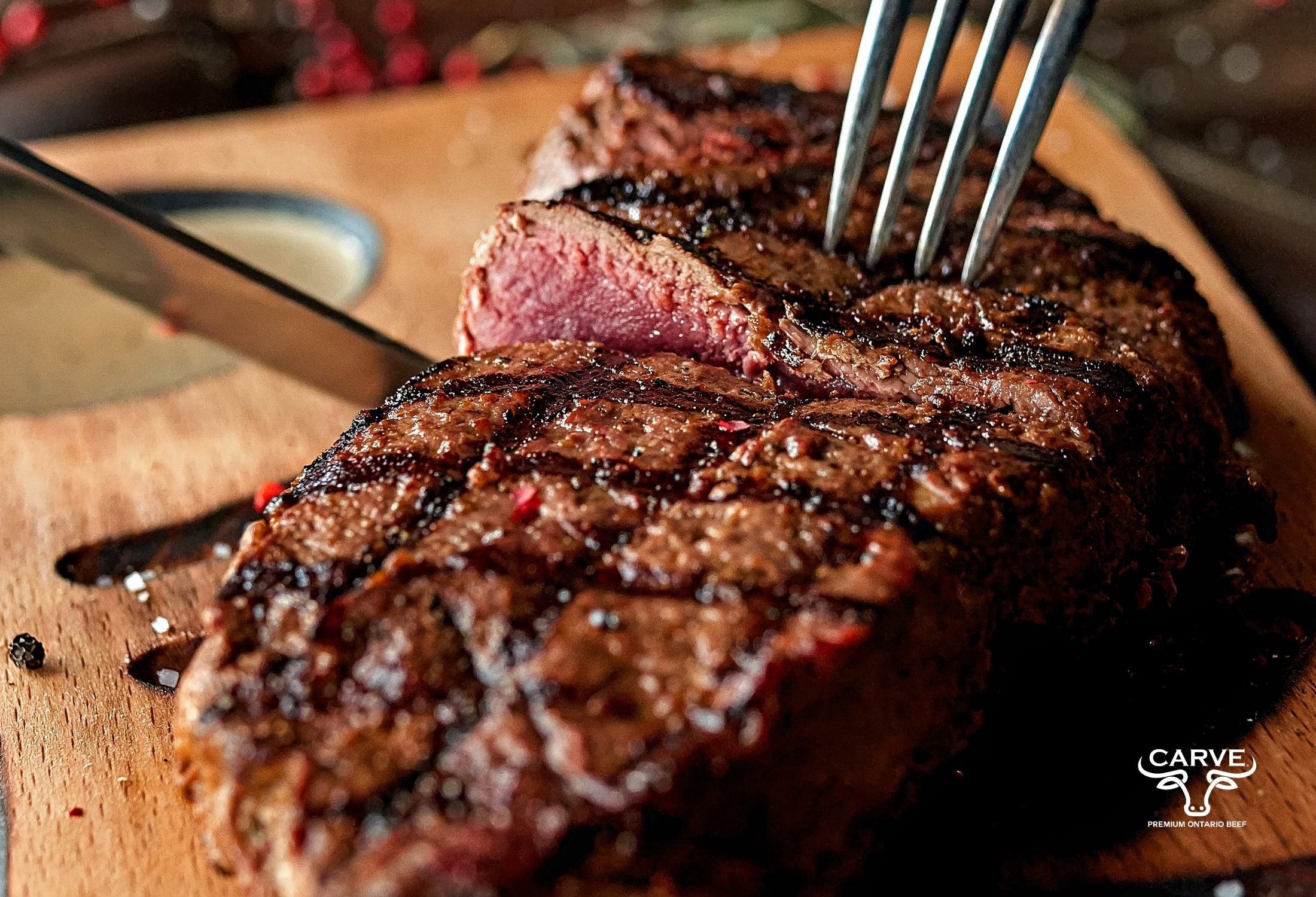 Cooked steak with person cutting into it